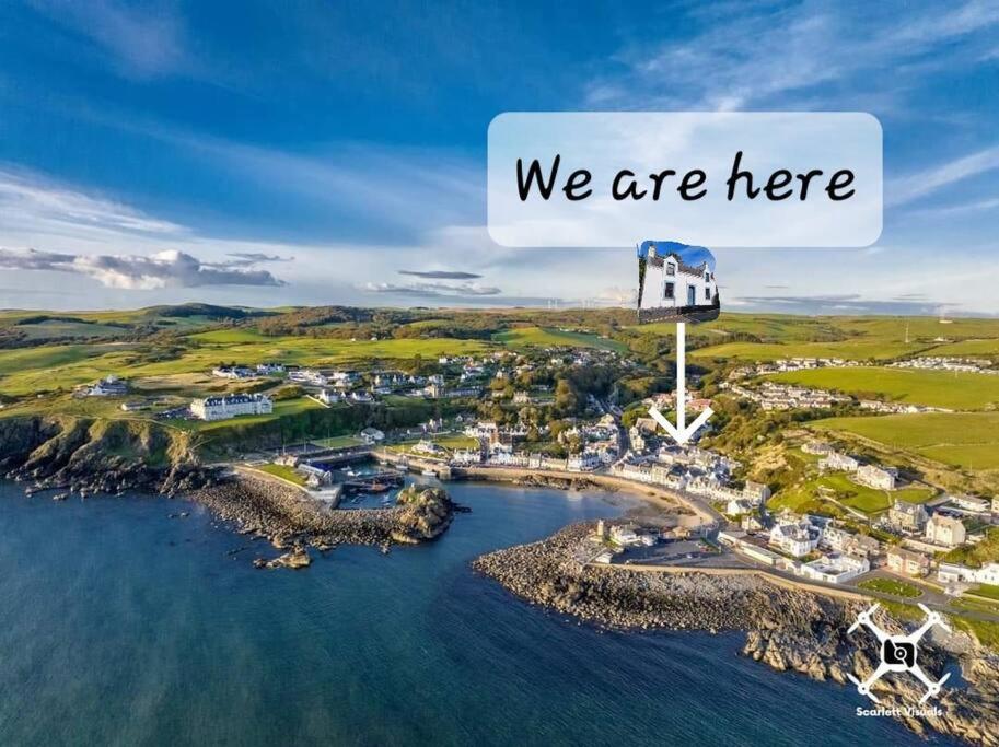 an island in the water with a sign that says we are here at The Portpatrick Pad - A cosy 3 bed cottage, w. sea views & garden office in Portpatrick