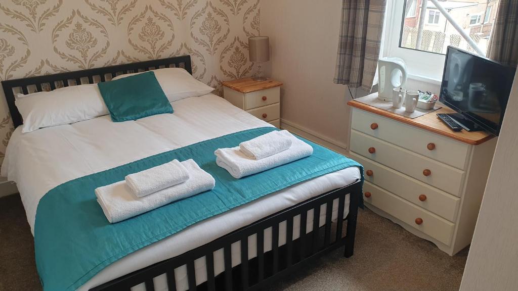 a bedroom with a bed with two pillows on it at HOTEL242 in Blackpool