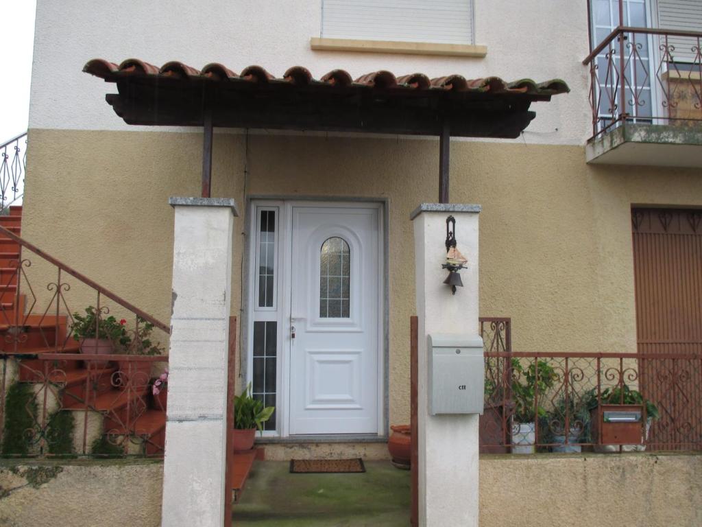 a white door of a house with a porch at Casa Valente in Macedo de Cavaleiros