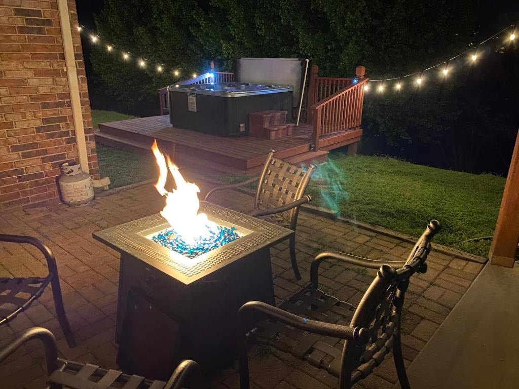 a patio with a fire pit and a grill with lights at 4BR Walk-in - Pool Table - Fire Pit - FREE TICKETS INCLUDED - DV164 in Branson