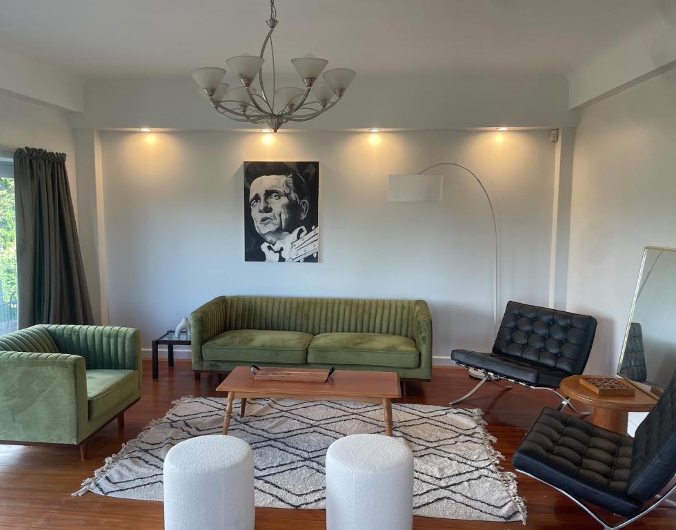 a living room with two couches and a table at CBD Apartment, River View in Hamilton