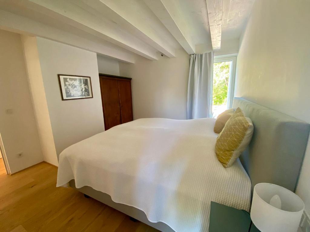 Postel nebo postele na pokoji v ubytování Seechalet Faaker See