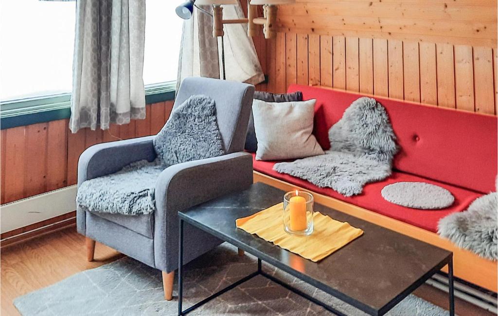 a living room with a red couch and two chairs at Amazing Home In Heggenes With 2 Bedrooms in Heggenes