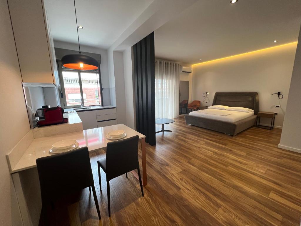 a bedroom with a bed and a table and a dining room at Skanderbeg Square Center Apartments in Tirana