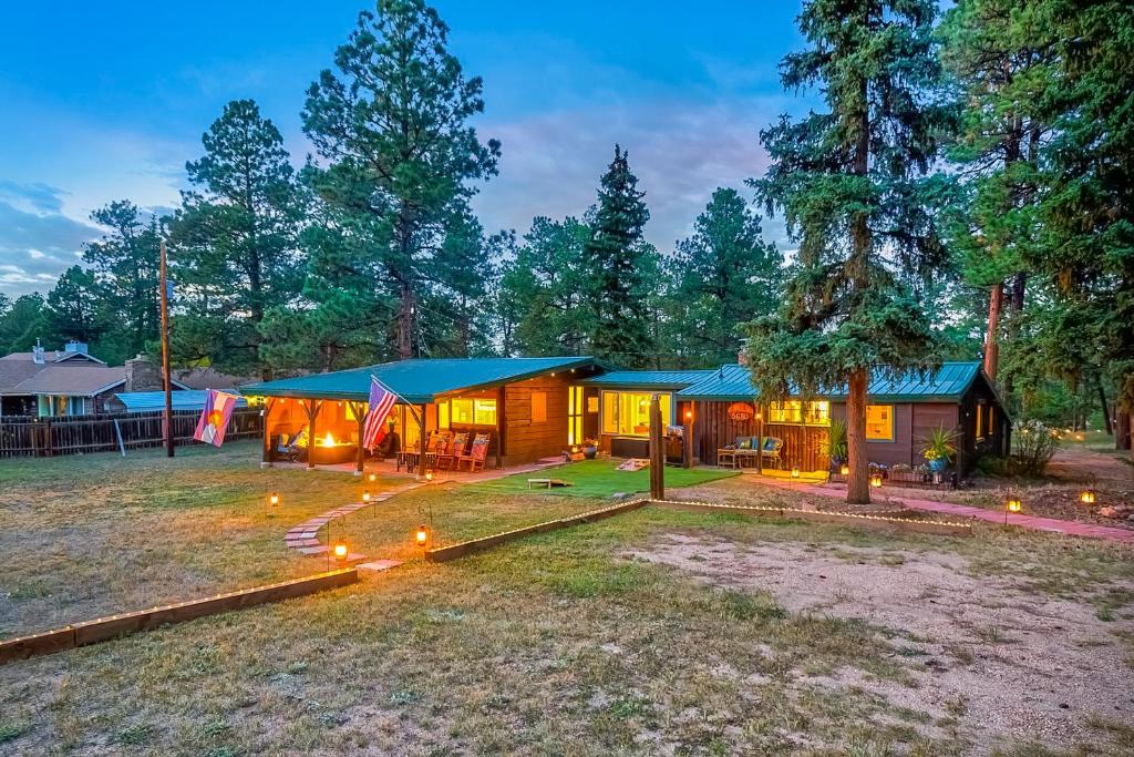 a house with a blue roof and lights on the yard at Cowboy Cabin Ranch in Colorado Springs