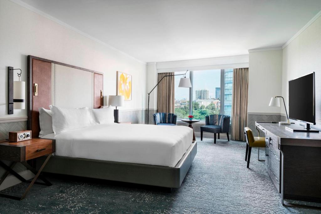 a hotel room with a bed and a desk at The Ritz-Carlton, Boston in Boston