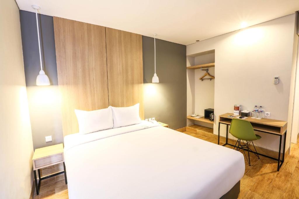 Postel nebo postele na pokoji v ubytování Hotel Citradream Semarang