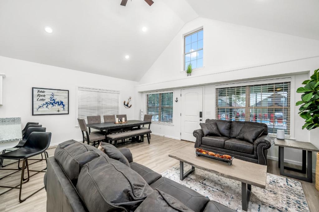 a living room with a couch and a table at 4BD Lodge at Table Rock Lake - Near Marina - Pool - BBH in Lampe