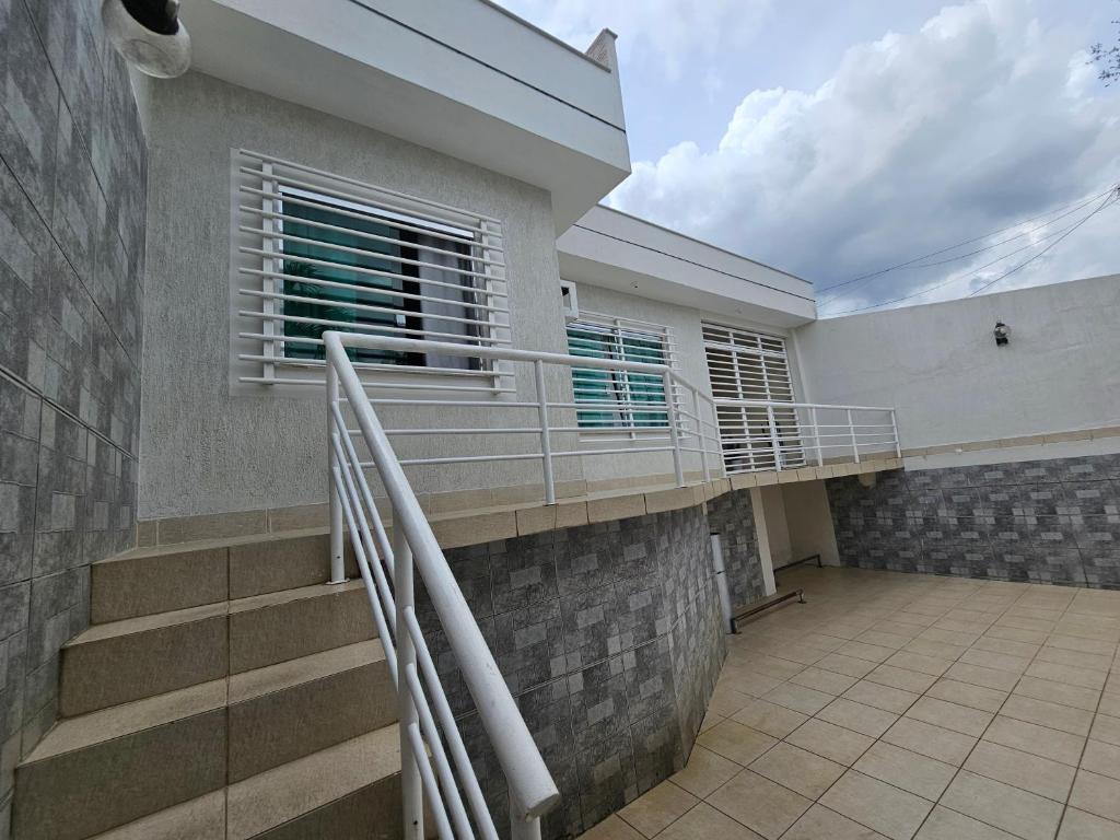 a house with a staircase and a balcony at Pousada 218 Manaus in Manaus