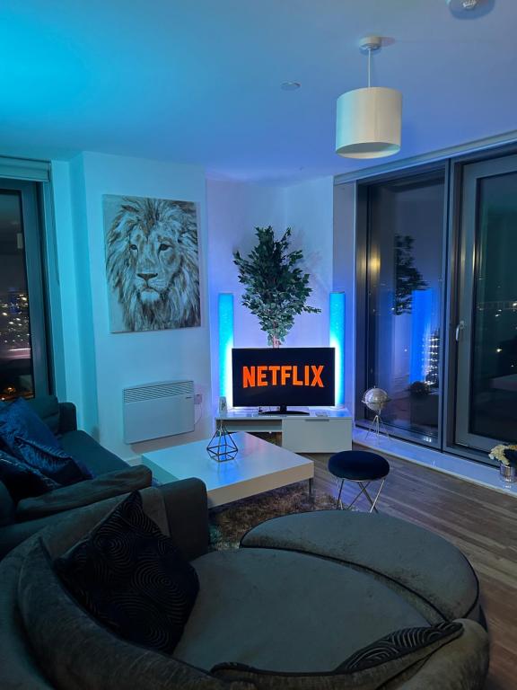 a living room with a couch and a television at Salford Quays Apartment, Manchester in Manchester