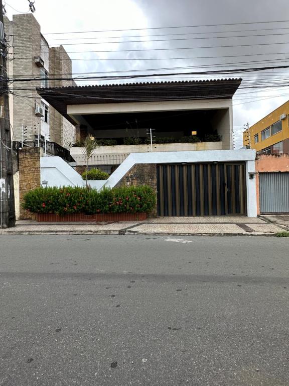 a building with a gate and a garage at Suítes no São Francisco - Casa de Hospedagem Ferreira in São Luís