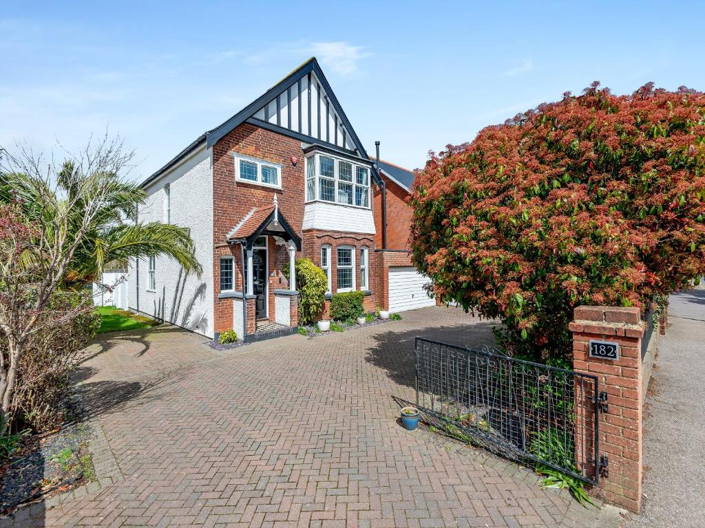 a brick house with a gate in front of it at Hill House in Sholden