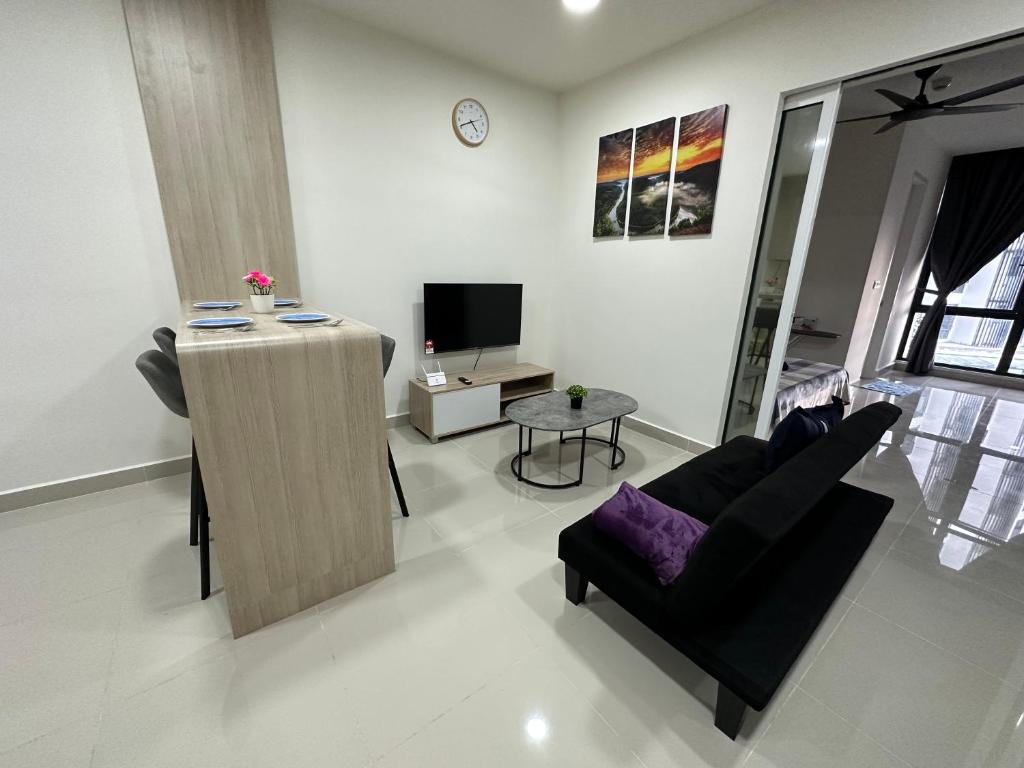 a living room with a couch and a tv at Sea View The Shore Luxury Newly Renovated Homestay in Kota Kinabalu