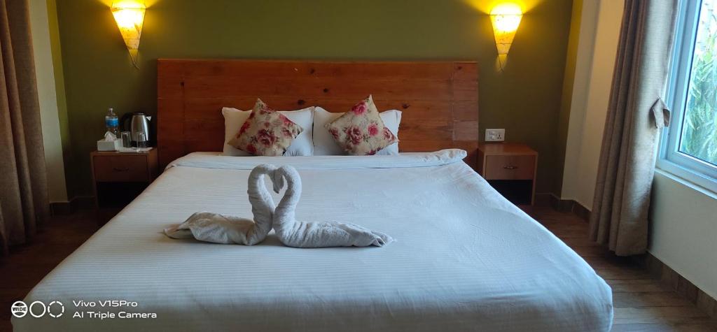 Postel nebo postele na pokoji v ubytování Hotel hornbill