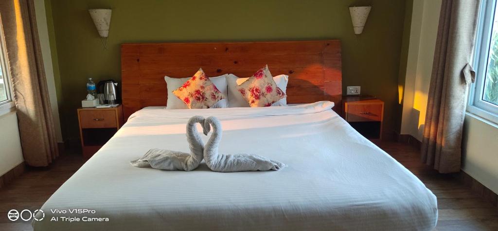 Postel nebo postele na pokoji v ubytování Hotel hornbill
