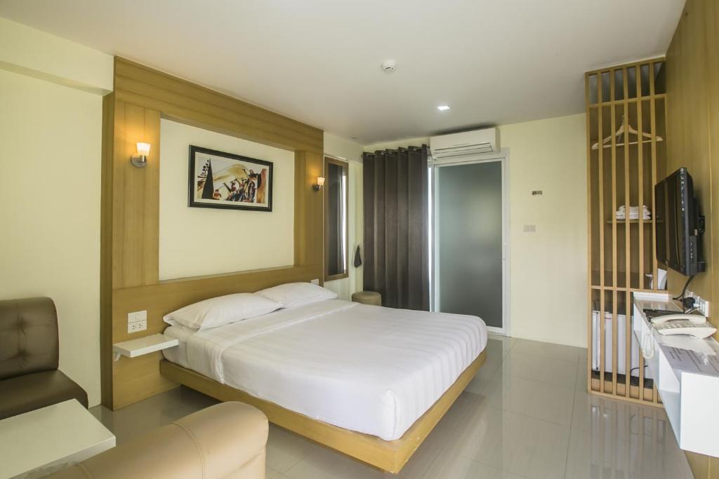 Postel nebo postele na pokoji v ubytování Petchsiri Boutique Hotel เพชรสิริ บูทิค