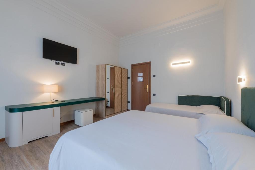 Postel nebo postele na pokoji v ubytování Hotel Gattapone