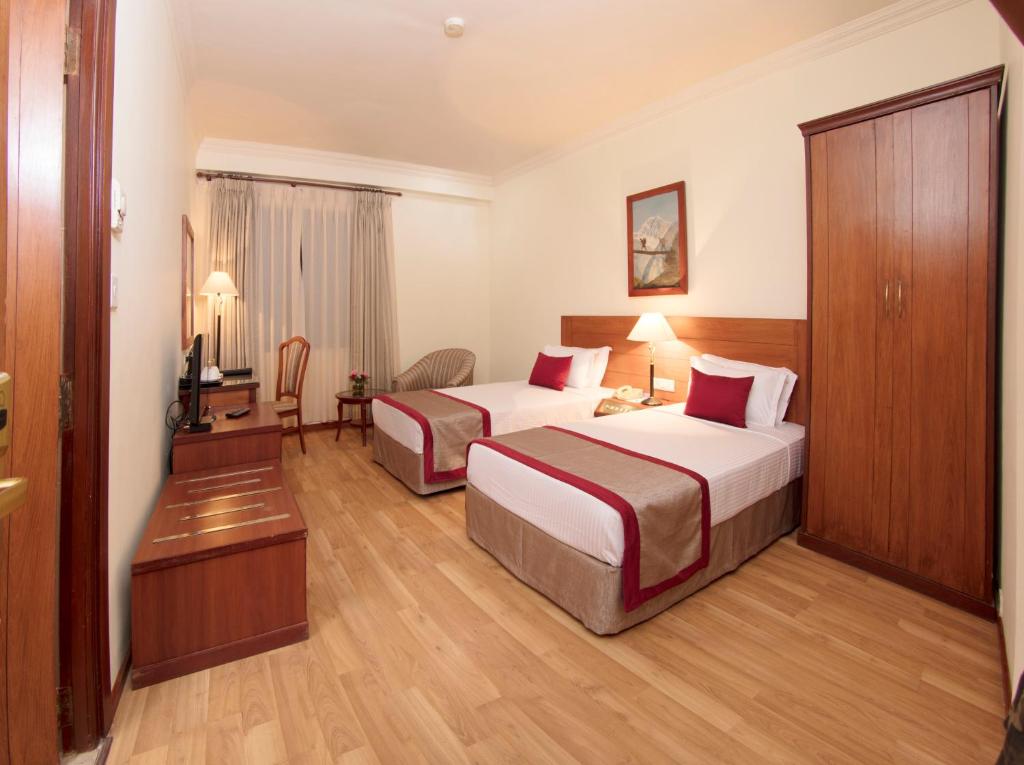 Postel nebo postele na pokoji v ubytování Royal Singi Hotel