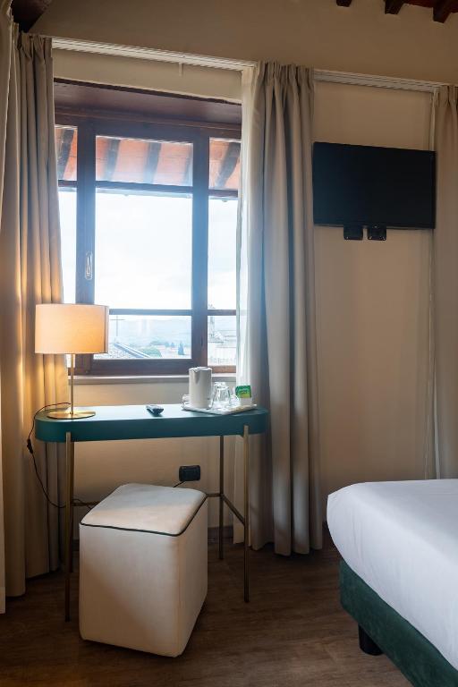 Postel nebo postele na pokoji v ubytování Hotel Gattapone