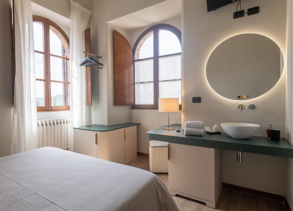 Postel nebo postele na pokoji v ubytování Hotel Gattapone