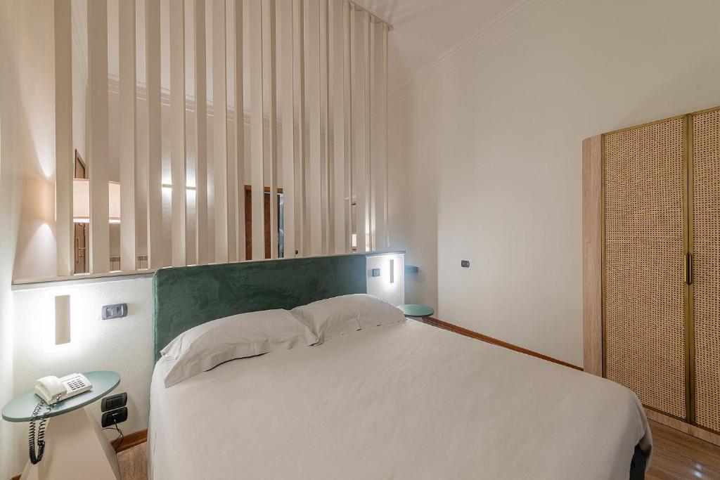 Postel nebo postele na pokoji v ubytování Hotel Gattapone