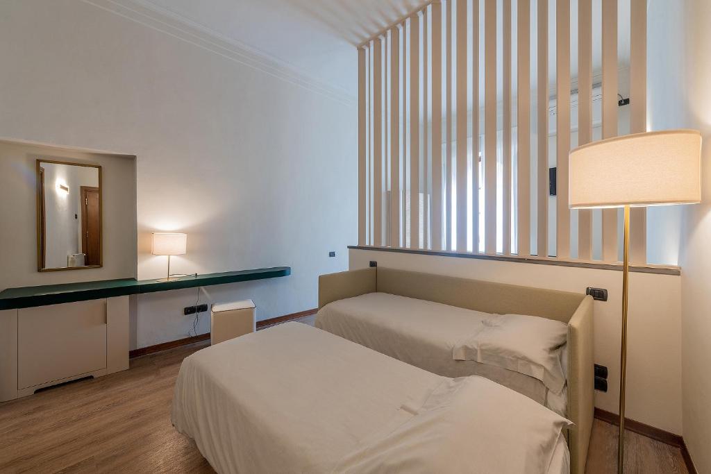 Postel nebo postele na pokoji v ubytování Hotel Gattapone