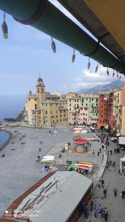 a group of people on a beach with buildings at Blue Windows in Camogli