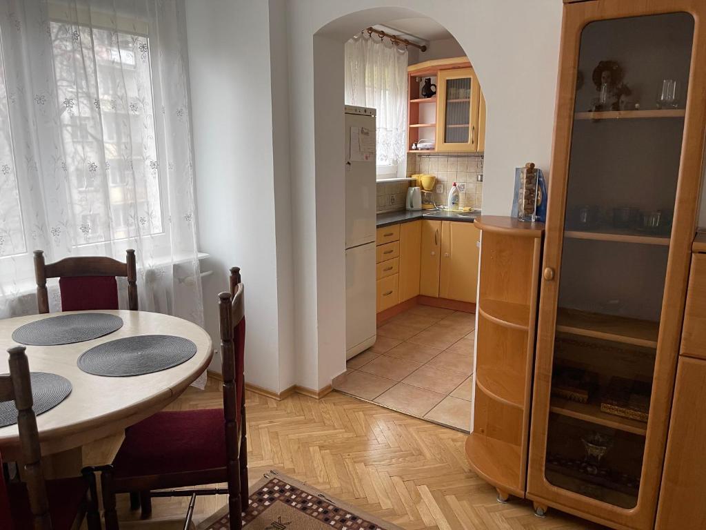 a kitchen with a table and a dining room at Mieszkanie Dla Turystów in Sandomierz