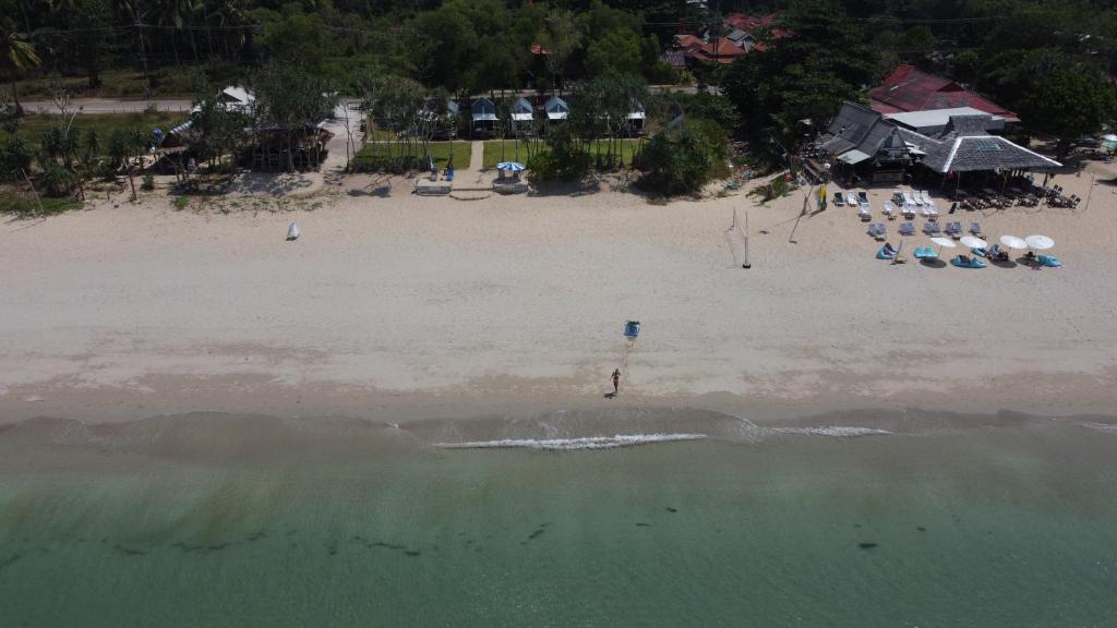 an aerial view of a beach with chairs and umbrellas at Walden Koh Lanta - Tiny Homes by the Sea in Ko Lanta