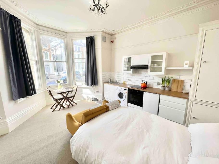 Habitación blanca grande con cama grande. en Bright & Relaxing Studio in Brighton & Hove en Brighton & Hove