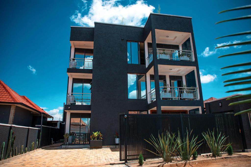 a black house with a fence in front of it at Senita Bed & breakfast in Kigali