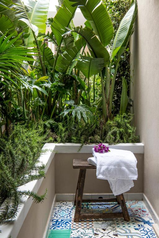 a bench with a towel on it sitting on a floor at Capri Tiberio Palace - The Leading Hotels of the World in Capri