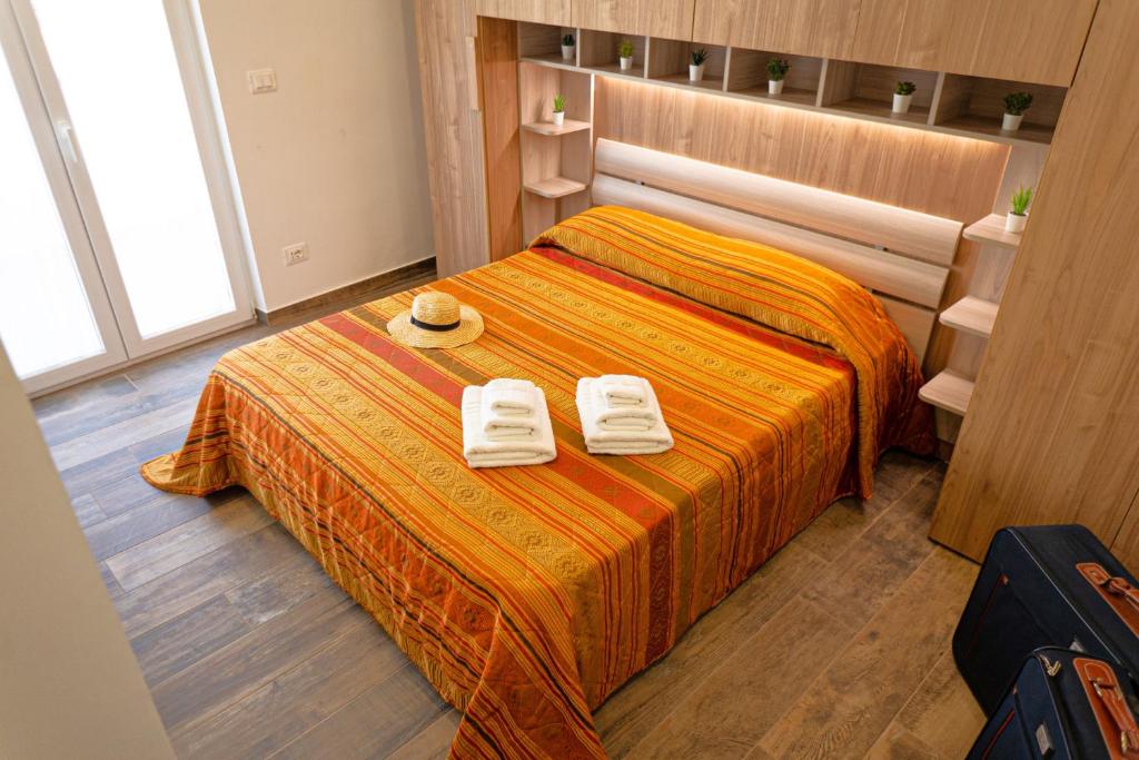 Stella di Mare GuestHouse tesisinde bir odada yatak veya yataklar