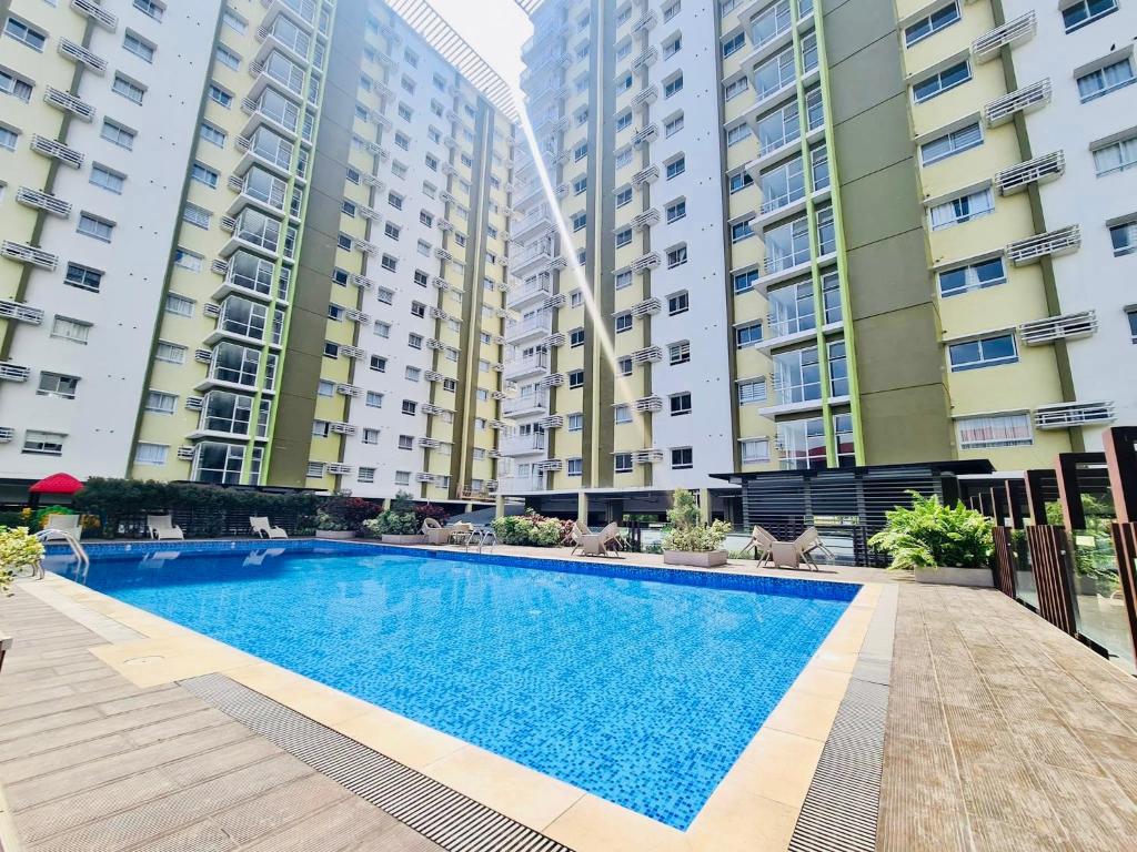 a swimming pool in front of two tall buildings at Studio unit at Mesaverte Residence in Cagayan de Oro