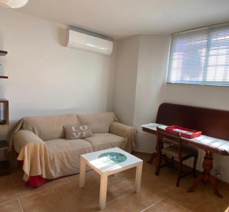 a living room with a couch and a table at Estudio LA HIGUERA in Argés