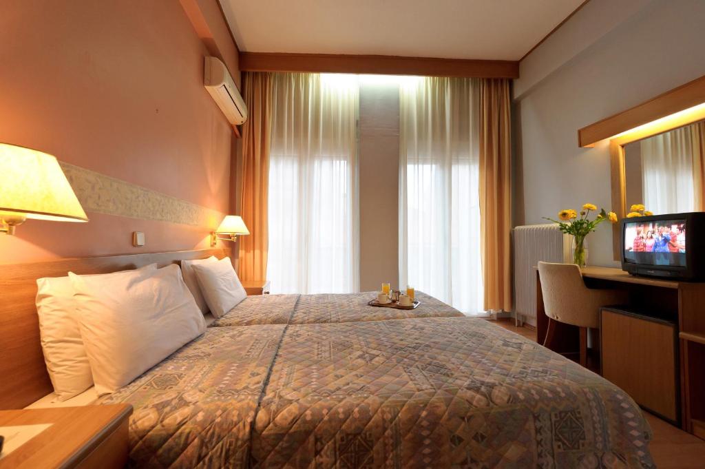 a hotel room with a bed and a television at Anesis in Kastoria