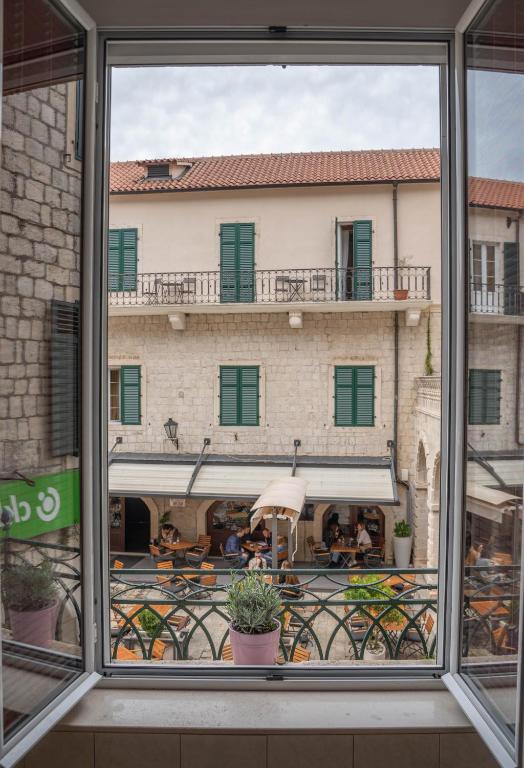 a view of a building from a window at Main Square View in Kotor