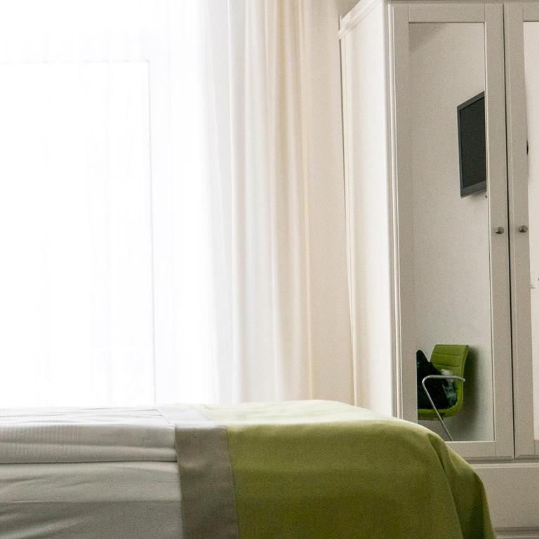 Postel nebo postele na pokoji v ubytování Hotel Villa Rückert