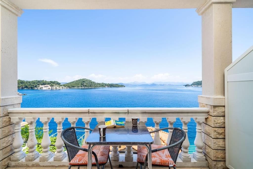 a table on a balcony with a view of the water at Lovely studio apartment in Sobra