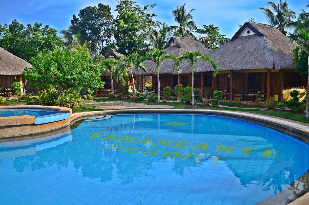a swimming pool in front of a resort at Veraneante Resort in Panglao Island