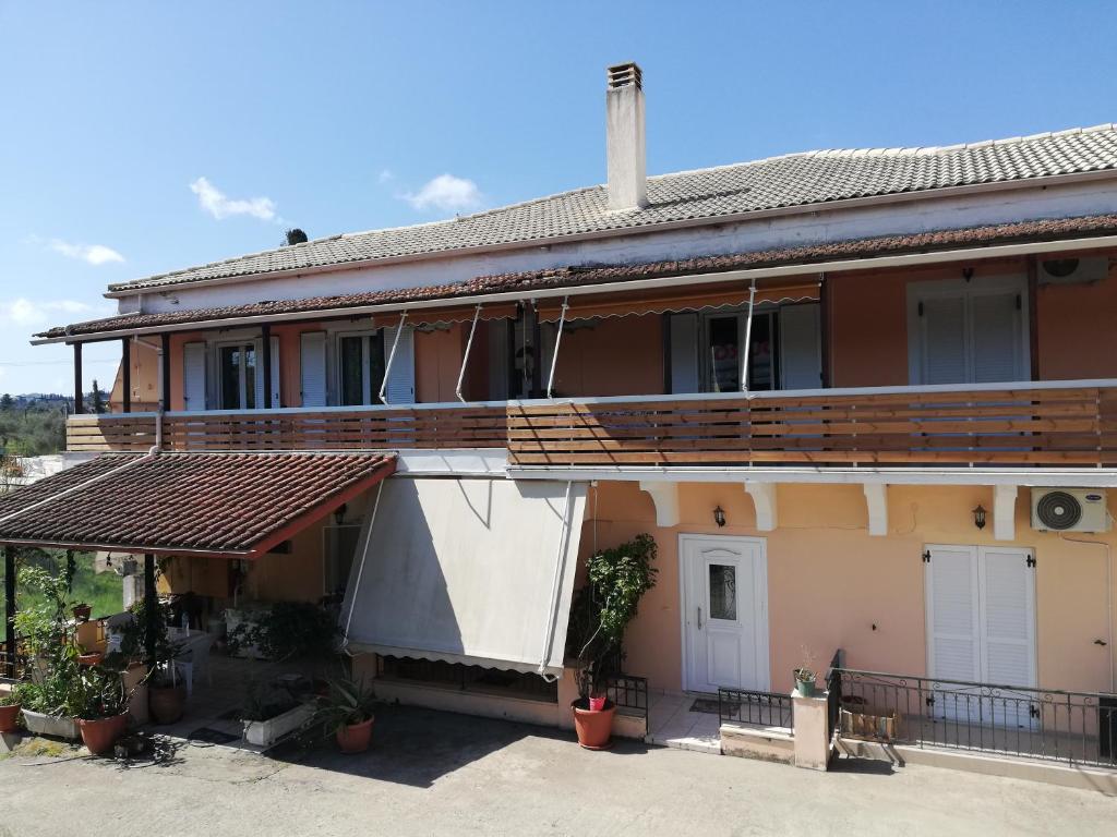 a house with a porch and a balcony at sapfo's house in Agios Ioannis