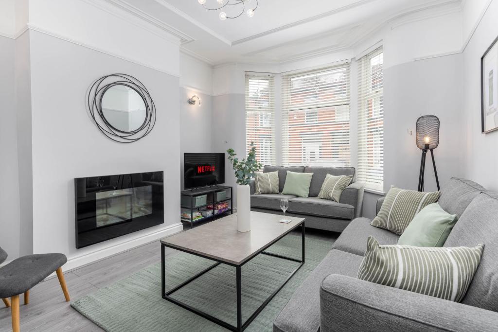 a living room with a couch and a table at Host Liverpool - Elegant Anfield Getaway in Liverpool