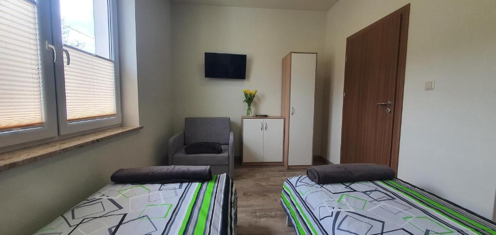 Postel nebo postele na pokoji v ubytování Zajazd Stronie