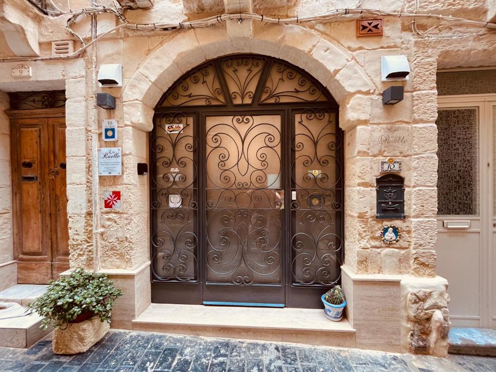 an entrance to a building with a large wooden door at 10 La Ruelle in Valletta