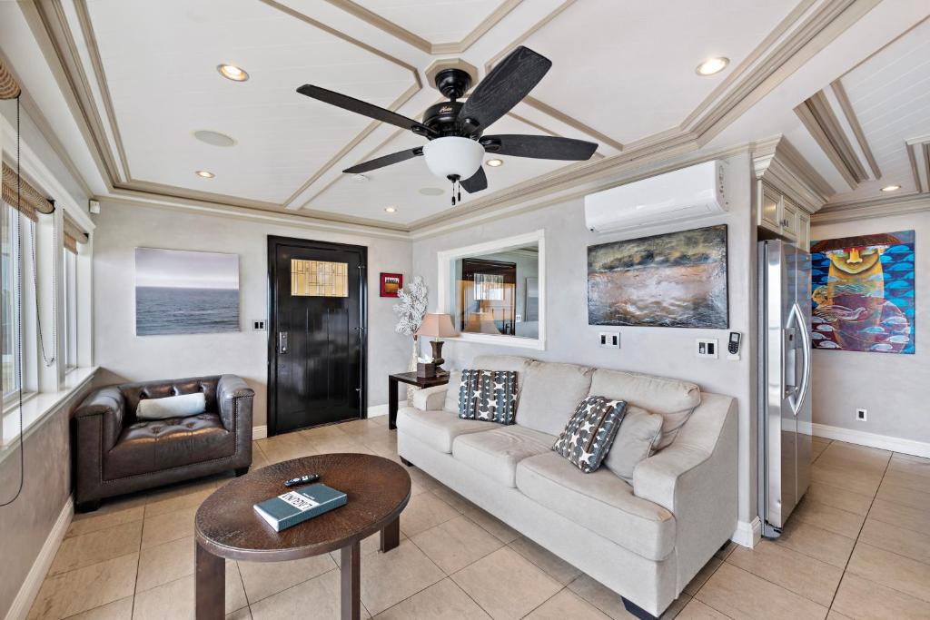 a living room with a couch and a ceiling fan at Villa Leone at the Retreat in Laguna Beach in Laguna Beach