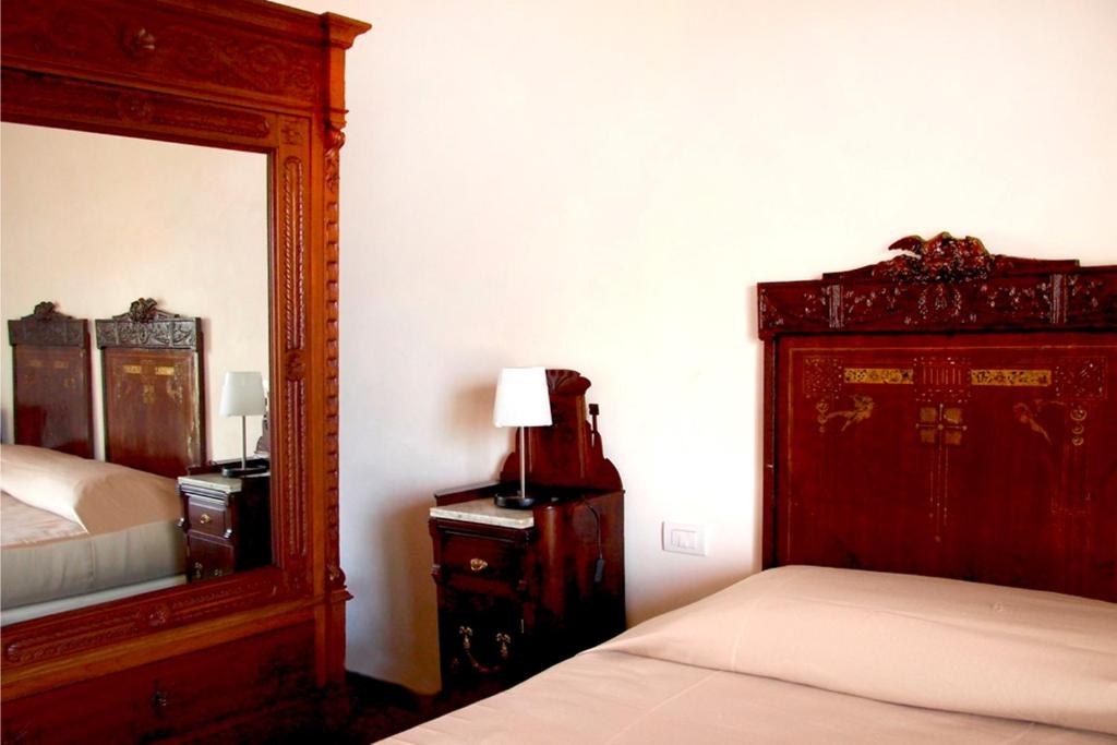 Postel nebo postele na pokoji v ubytování Hotel Dell'Orologio