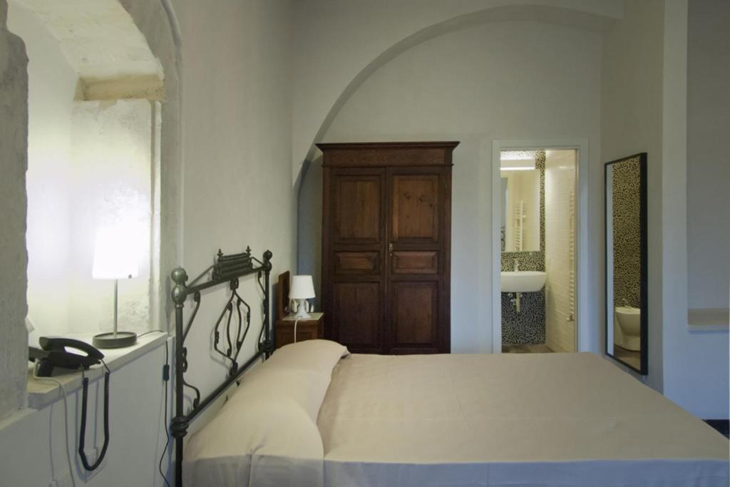 Postel nebo postele na pokoji v ubytování Hotel Dell'Orologio