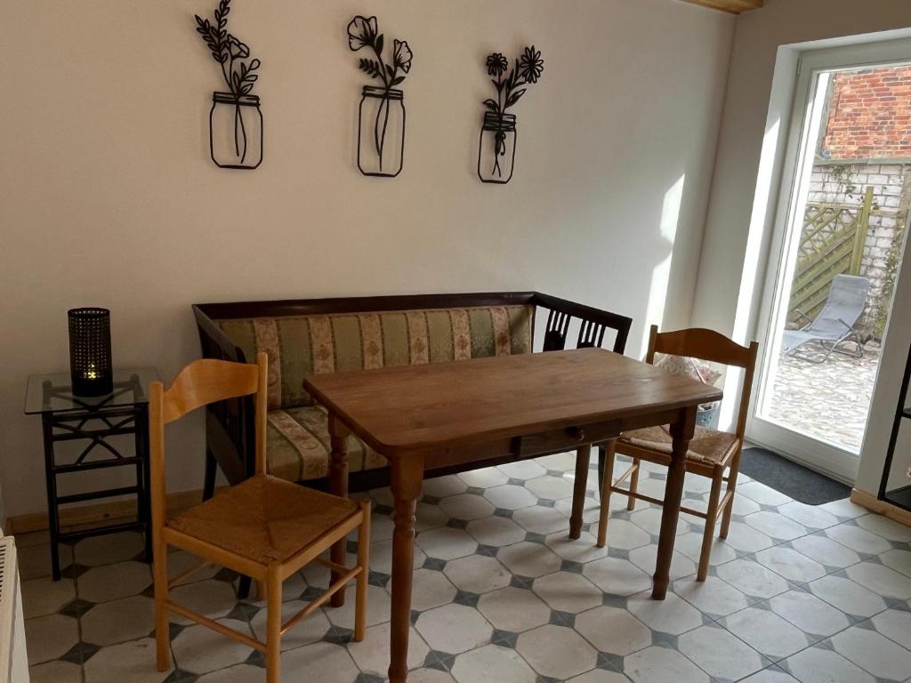 a dining room with a wooden table and chairs at Stadthaus Usedom in Usedom Town