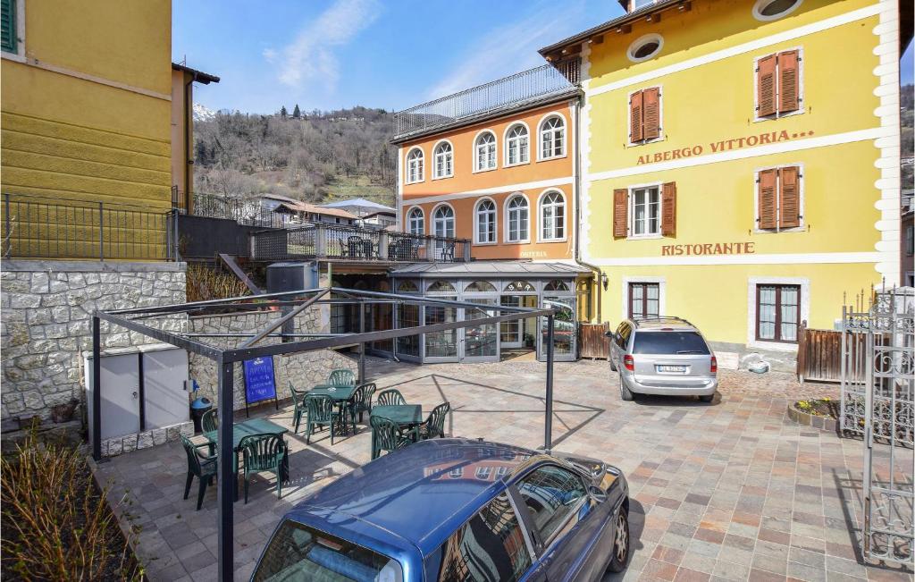 a car parked in a parking lot next to a building at Beautiful Apartment In Roncegno Terme With Wifi And 2 Bedrooms in Marter di Roncegno