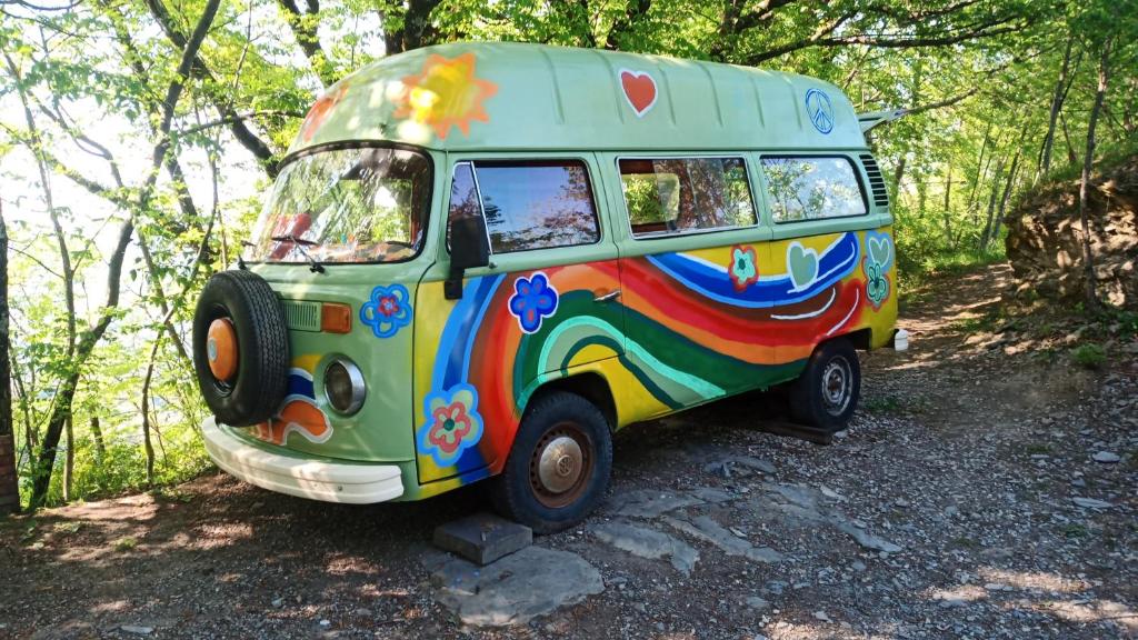 a colorful bus parked on the side of a road at @gatetothewild in Coreglia Ligure